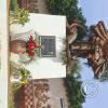 Statue next to the city name sign