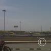 Two horse drawn wagons carrying stuff on the highway