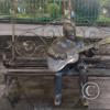 Sculpture of guitar player on a bench alongside Parque Central