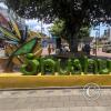 City name sign in median of Av Unidad Nacional near Av Policia Nacional