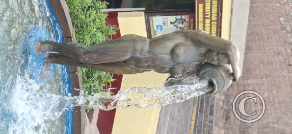 Statue of naked woman pouring water at Plazoleta Santa Teresa